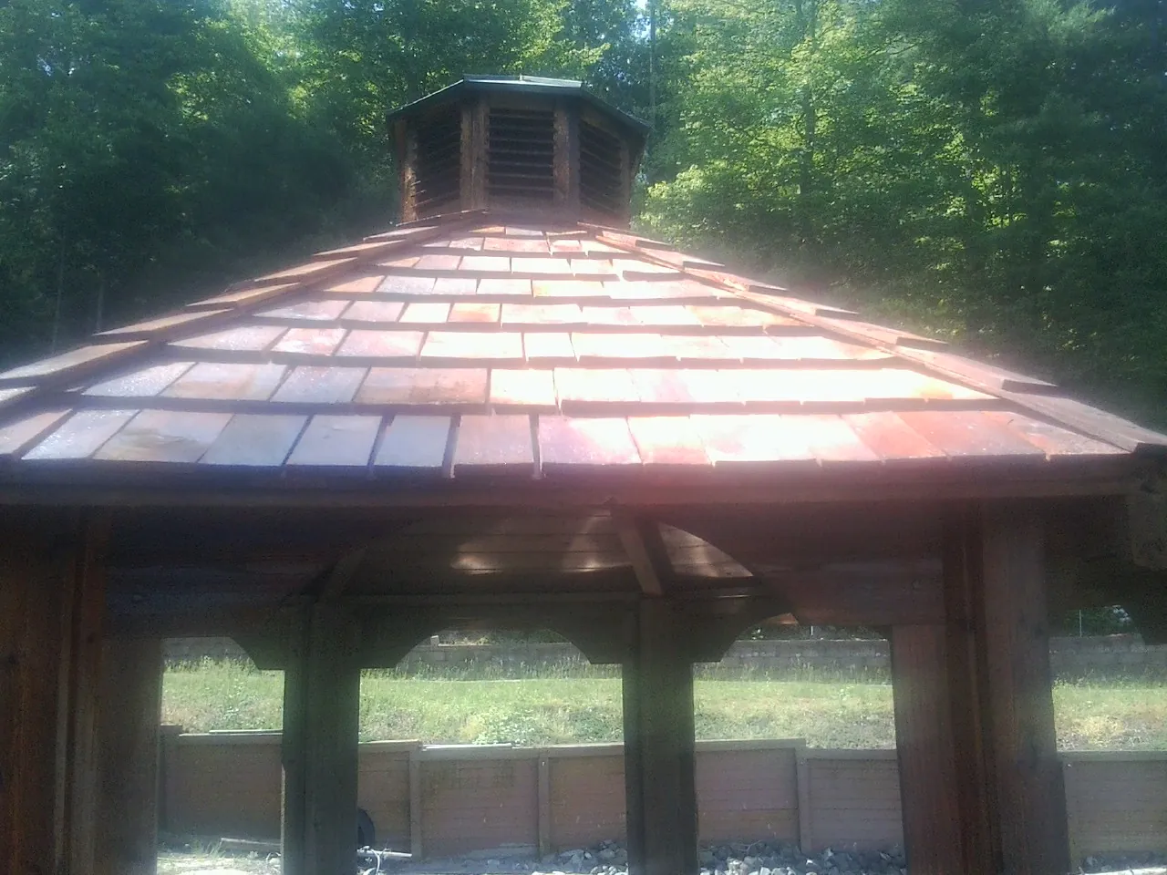 New cedar shake roof and cupola on a lakeside gazebo in Derry